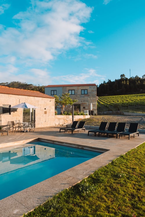 Canhoto Douro poolside with loungers, stone house, vineyard views in São Lourenço do Douro