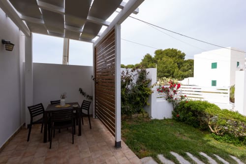 Medusa apartment at Senia del Rais in Favignana with covered patio dining area and garden view