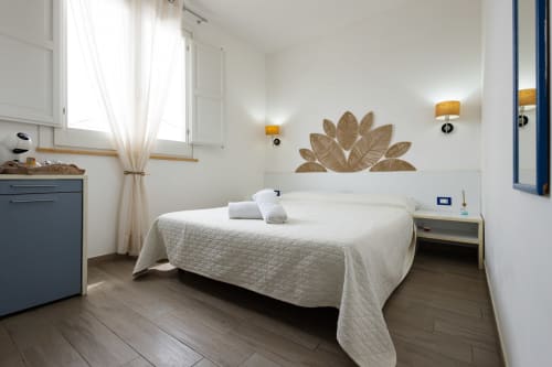 Stella Marina room at Senia del Rais B&B in Favignana with ocean view, white bed, modern amenities and natural decor