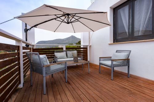 Stella Marina terrace at Senia del Rais in Favignana with ocean view, cantilever umbrella, and modern outdoor seating