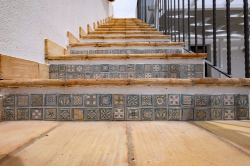Decorative blue and gold tile staircase with wooden railings in Favignana guesthouse Corallo room