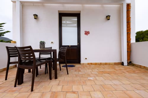 Outdoor terrace at Senia del Rais in Favignana with dining furniture and sea view access