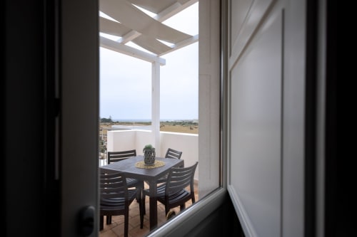 Corallo room terrace at Senia del Rais in Favignana with dining table, chairs, and sea views