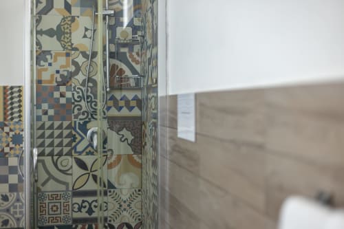 Decorative patterned tile shower enclosure at Senia del Rais B&B in Favignana