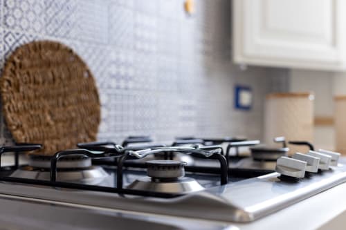 Modern gas stovetop with knobs in Sardina apartment kitchen at Senia del Rais, Favignana