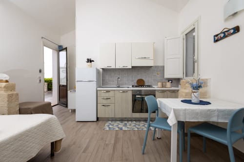 Modern studio apartment at Senia del Rais in Favignana with kitchen, dining area, and mountain views