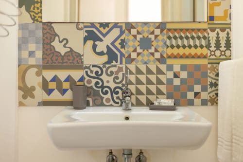 Bathroom sink with decorative patterned tile backsplash at Senia del Rais, Favignana apartment