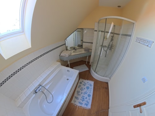 Bathroom in Chambre Jaune at Ferme De La Sensee B&B with bathtub, shower enclosure, and wooden flooring in Gouy Sous