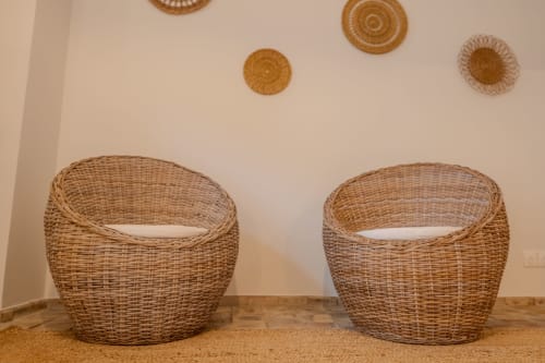 Two woven wicker chairs in rustic French bedroom at Mas Bella Cortis, La Garde-Adhémar