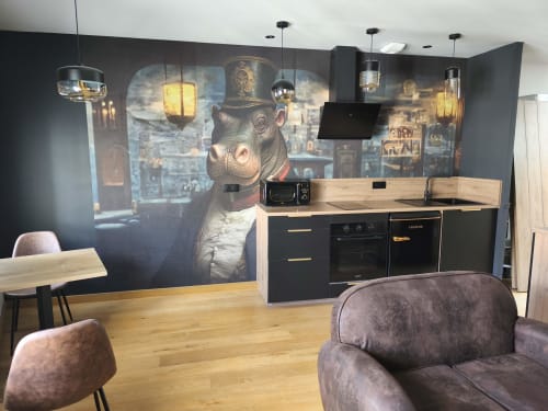 Hippo Loft à Escale à Clisson : kitchenette moderne avec électroménagers noirs, coin repas en bois, sièges gris et ambiance artistique