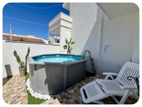 Private pool with loungers on sunny terrace at Villa Adua, Ostuni Italy