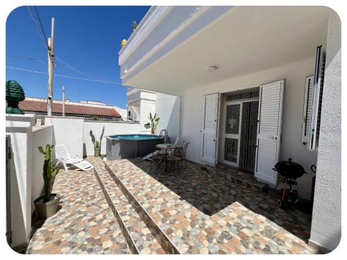 Villa Adua's private patio with blue pool, outdoor dining area, and lounge seating in Ostuni, Italy