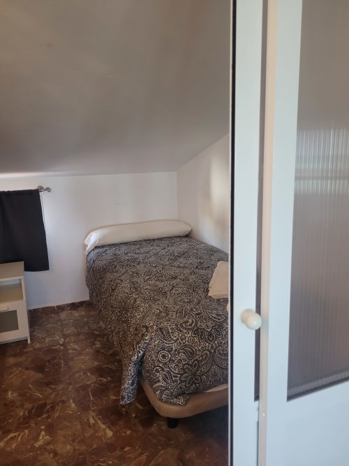 Dormitorio en apartamento dúplex de Apartamentos A la Orilla del Mar, Matalascañas, con cama y ropa de cama estampada