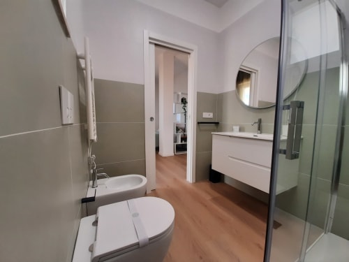 Moderno bagno con doppio lavabo, toilette, doccia e specchio all'hotel Urban View Bari a Bari, Italia