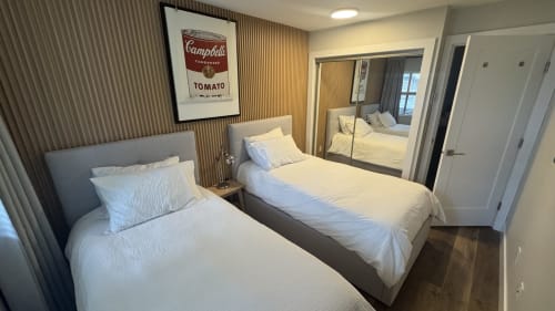 Modern bedroom with two twin beds, mirrored closet, and Campbell's tomato soup artwork in Whistler apartment