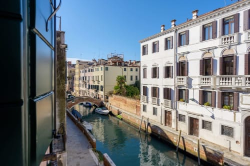 Venetian canal view from Bealux San Vio villa with historic buildings and moored boats, Venezia