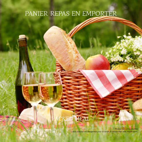Picnic basket with wine, bread, and fruit on grass at Mas le Châtelet hotel near St Paul de Fenouillet