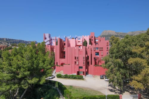 Red modern apartment building Riurau Home in Calpe, Spain, surrounded by Mediterranean vegetation and mountains