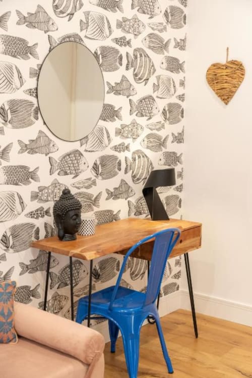 Deluxe Double Room at Suite Maradona Naples: wooden desk with blue chair, oval mirror, fish-patterned wallpaper, woven heart