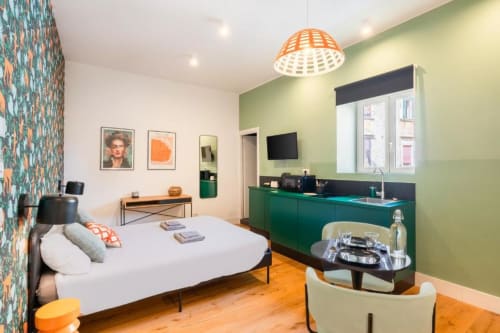 Suite Maradona Superior Double Room in Naples with bed, green kitchenette, desk, and modern amenities