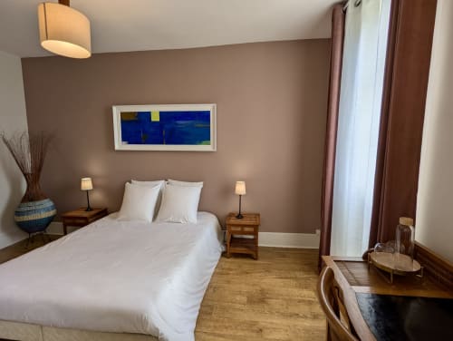 Bedroom in Suite Les Clos at Domaine du Faure B&B, Chadurie with queen bed, garden view artwork, wooden nightstands and