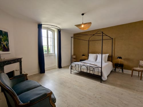 Suite élégante au Domaine du Faure avec lit à baldaquin, cheminée et vue sur le jardin à Chadurie, France