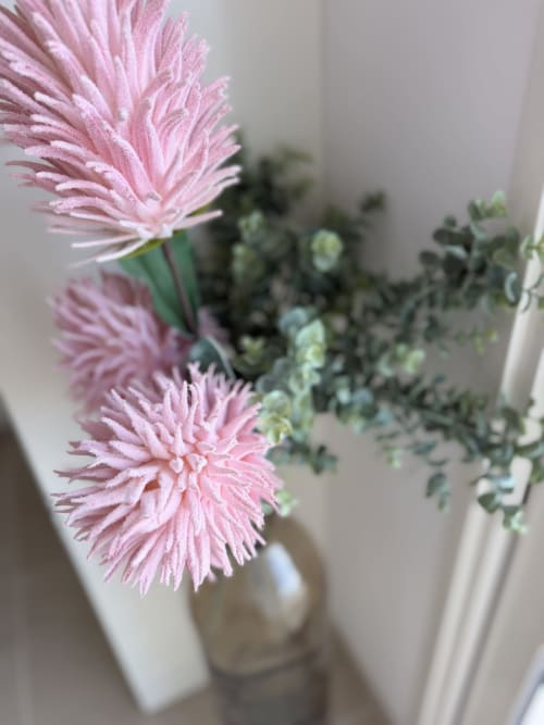Gerberas roses avec eucalyptus dans un vase blanc au Petit Coin de Paradis, Alata