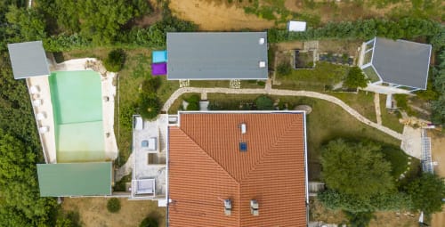 Aerial view of Villa Fiorenza in Quartu Sant'Elena showing terracotta roof, private pool, garden, and surrounding villas with