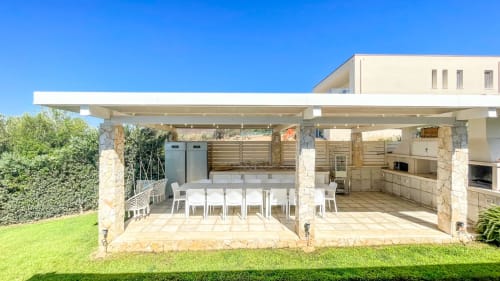 Outdoor kitchen and dining area at Villa Fiorenza in Quartu Sant'Elena, Sardinia with sea views