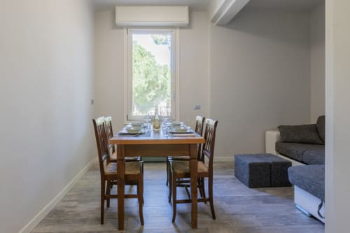 Moderna sala da pranzo dell'Hotel Prince Garda a Serniga con tavolo in legno, sedie e vista sul lago dalla grande finestra