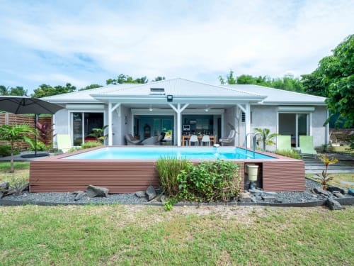 Modern villa with pool at ILMO Conciergerie in Le Gosier, featuring white architecture and terrace
