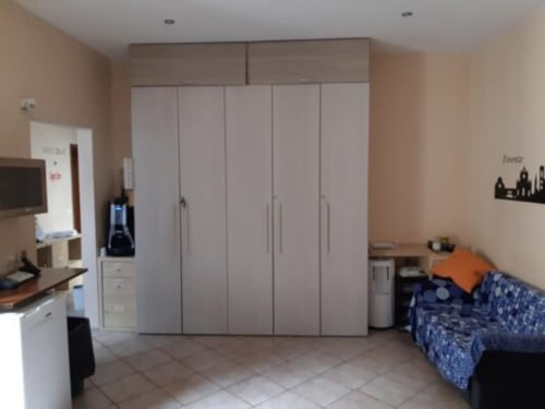 Modern bedroom at Sogni D'Oro Guest House in Florence with wardrobe, bed, kitchenette and work area