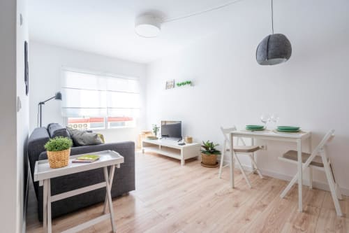 Interior moderno del apartamento de Nerja con mesa de comedor, zona de estar e iluminación natural brillante desde las ventanas