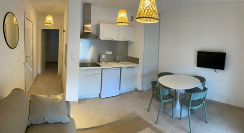 Modern T2 apartment at Résidence Marina di Bravone with open kitchen, dining area, and living space in Linguizzetta