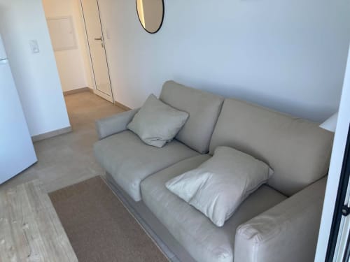 Beige sofa with white pillows in Room 47 at Résidence Marina di Bravone, Linguizzetta apartment