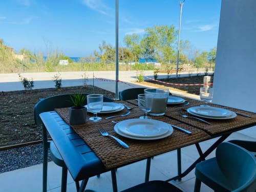 Outdoor dining table at Résidence Marina di Bravone with sea view, Linguizzetta