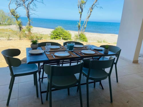 Table de restaurant en bord de mer à la Résidence Marina di Bravone, Linguizzetta, avec vue sur la mer et plage de sable