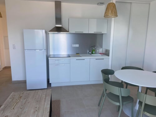 Modern kitchen and dining area in Marina di Bravone T3 apartment, Linguizzetta with stainless steel appliances