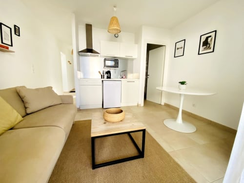 Modern apartment at Résidence Marina di Bravone, Linguizzetta with open-plan living, kitchenette, yellow sofa, and minimalist