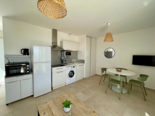 Modern kitchen and dining area in T3 apartment at Résidence Marina di Bravone, Linguizzetta with white appliances and green