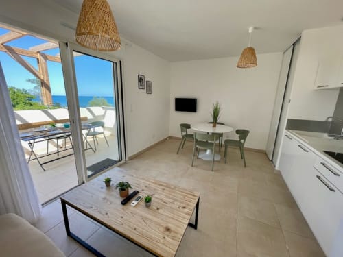 Modern apartment at Résidence Marina di Bravone with sea view, dining area, kitchen, and direct beach access in Linguizzetta