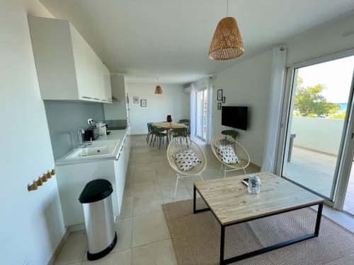 Modern apartment at Résidence Marina di Bravone with kitchen, living area, and sea view terrace