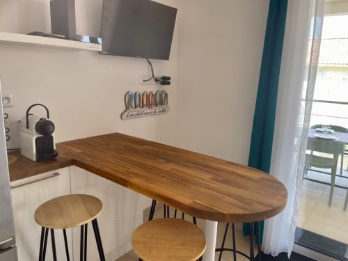 Modern kitchenette with wooden counter and bar seating at Résidence Marina di Bravone, Linguizzetta