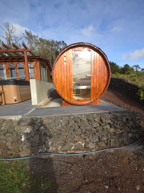 Wooden barrel-shaped sauna at Casa da Ioio villa, Adega da Quinta hotel in Madalena, Portugal with sea views