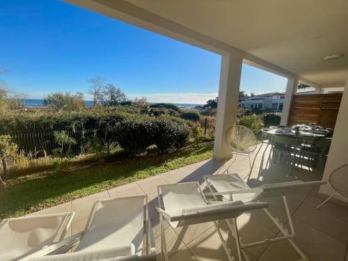 Marina di Bravone beachfront apartment terrace with loungers, garden, and sea view in Linguizzetta