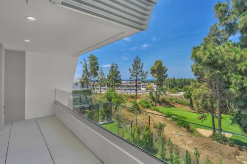 Nowoczesny balkon w rezydencji HomyMarbella z widokiem na ogród, pole golfowe i palmy w Elvirii