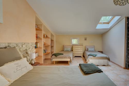 Chambre spacieuse à la Gîte Lavande du Domaine Bellavigne avec deux lits, rangements intégrés, puits de lumière et vue sur le jardin