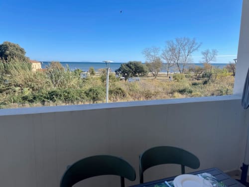 Sea view from Résidence Marina di Bravone apartment balcony overlooking beach and Mediterranean coastline
