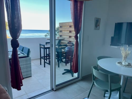 Marina di Bravone beachfront apartment in Linguizzetta with sea view balcony, dining area, and modern furnishings