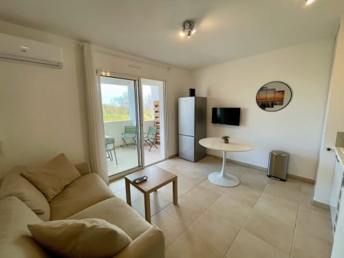 Cosy T2 apartment at Marina di Bravone with beachfront views, modern living area, and terrace access
